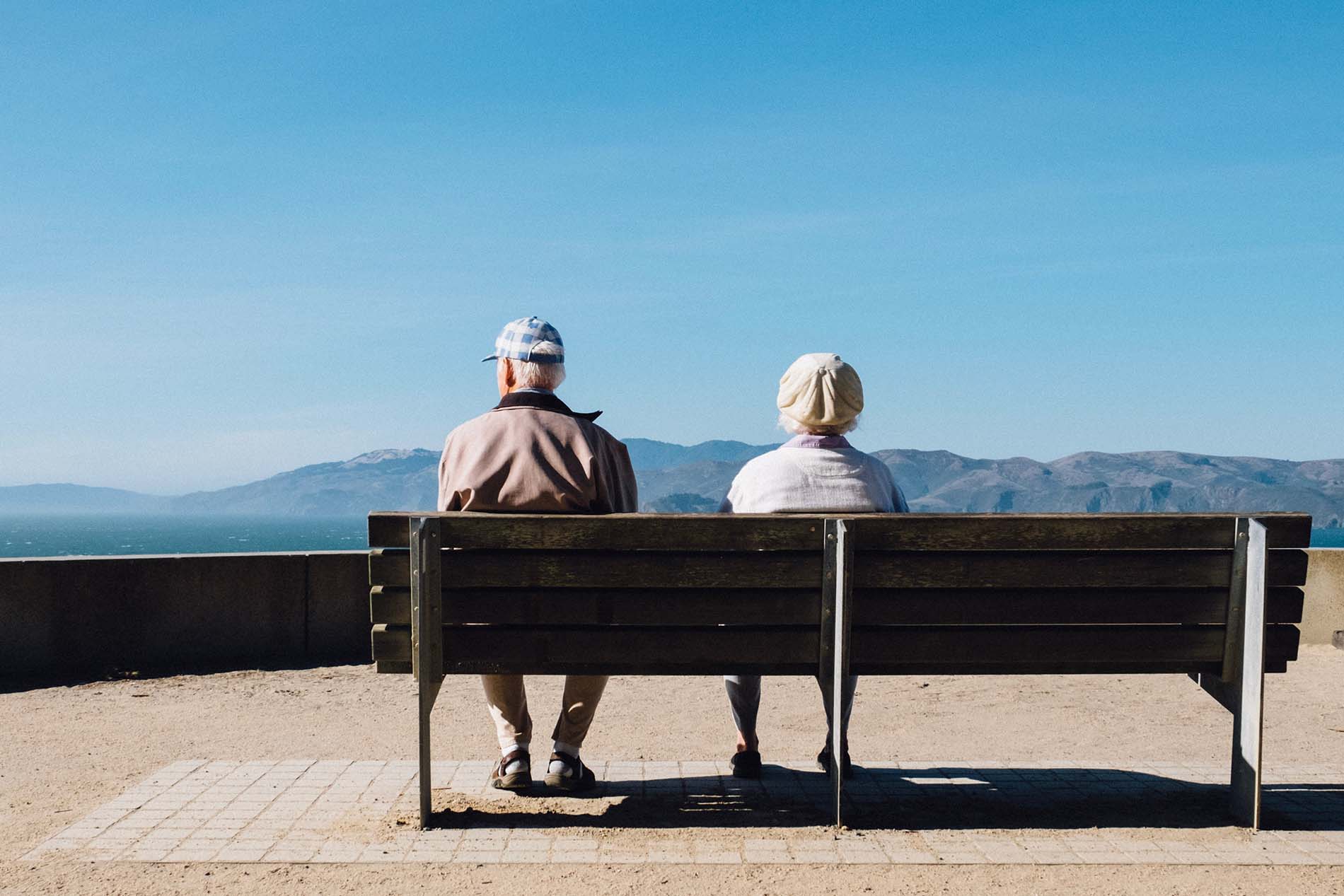 senior couple on a bench mountain overlook