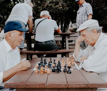 seniors playing chess in the park