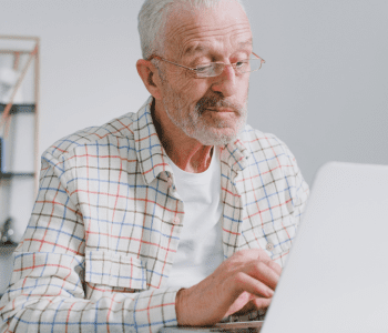 older man working on laptop