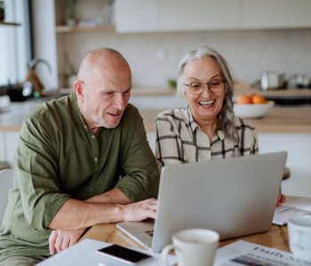 older adult couple on laptop