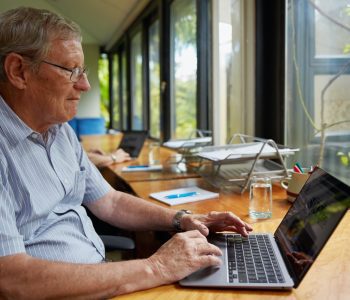older adult using laptop