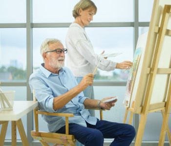 older adult couple with painting hobby in a bright room