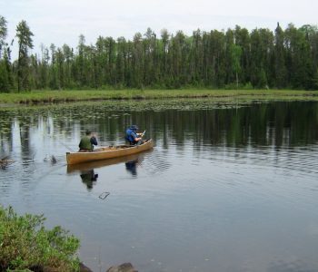 older adults in a canoe on the water