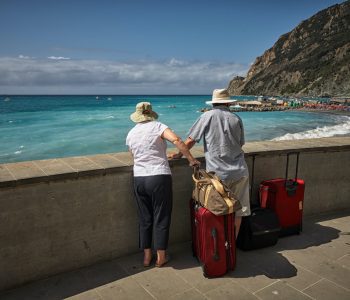 senior couple traveling with suitcases