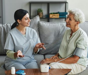 assisted living nurse caring for senior woman
