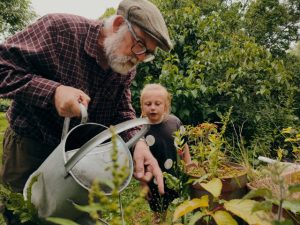 senior man with grandchild in garden